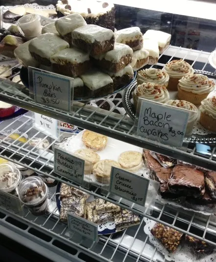 The Blue Moon Bakery pastry case with pumpkin bars, maple bacon cupcakes, peanut butter bars and cream cheese brownies